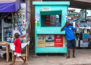 Dauda Musa,(standing) who runs a mobile money transfer business in Accra, and as the number of people with mobile phones has grown over the past few years, more people are using his service for business or to share money with friends and family. 