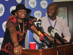 Award-winning vocalist Diamond Platnumz (left) shares his excitement for Tigo Music; the country's first mobile app that provides Tanzanians with unlimited access to music. To his left, Tigo Brand Manager, William Mpinga