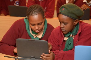 Students admiring a model classromm laptop that was unveiled by kenya private school association (KPSA) and Intel at an event held recently