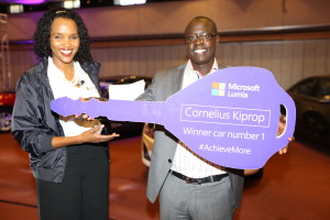 Microsoft Mobile devices GM for East Africa Ms. Mariam Abdullahi with one of the 5 Chevrolet cruze Winner Cornelius Kiprop.