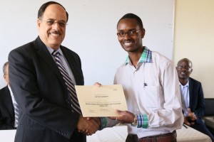 Third-year-Computer-Technology-student-Peter-Kabonyi-right-receives-an-IMB-Academic-Certificate-from-Dr.-Attia-300x200