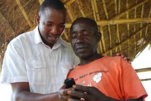 A farmer being taken through WeFarm service and how it works.