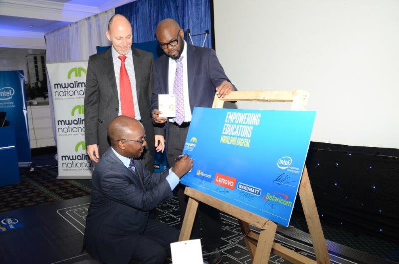 INTEL East Africa General Manager, Danie Steyn and Microsoft’s General Manager for East Africa- Kunle Awosika look on as Mwalimu National Sacco CEO- Robert Shibutse signs the agreement.