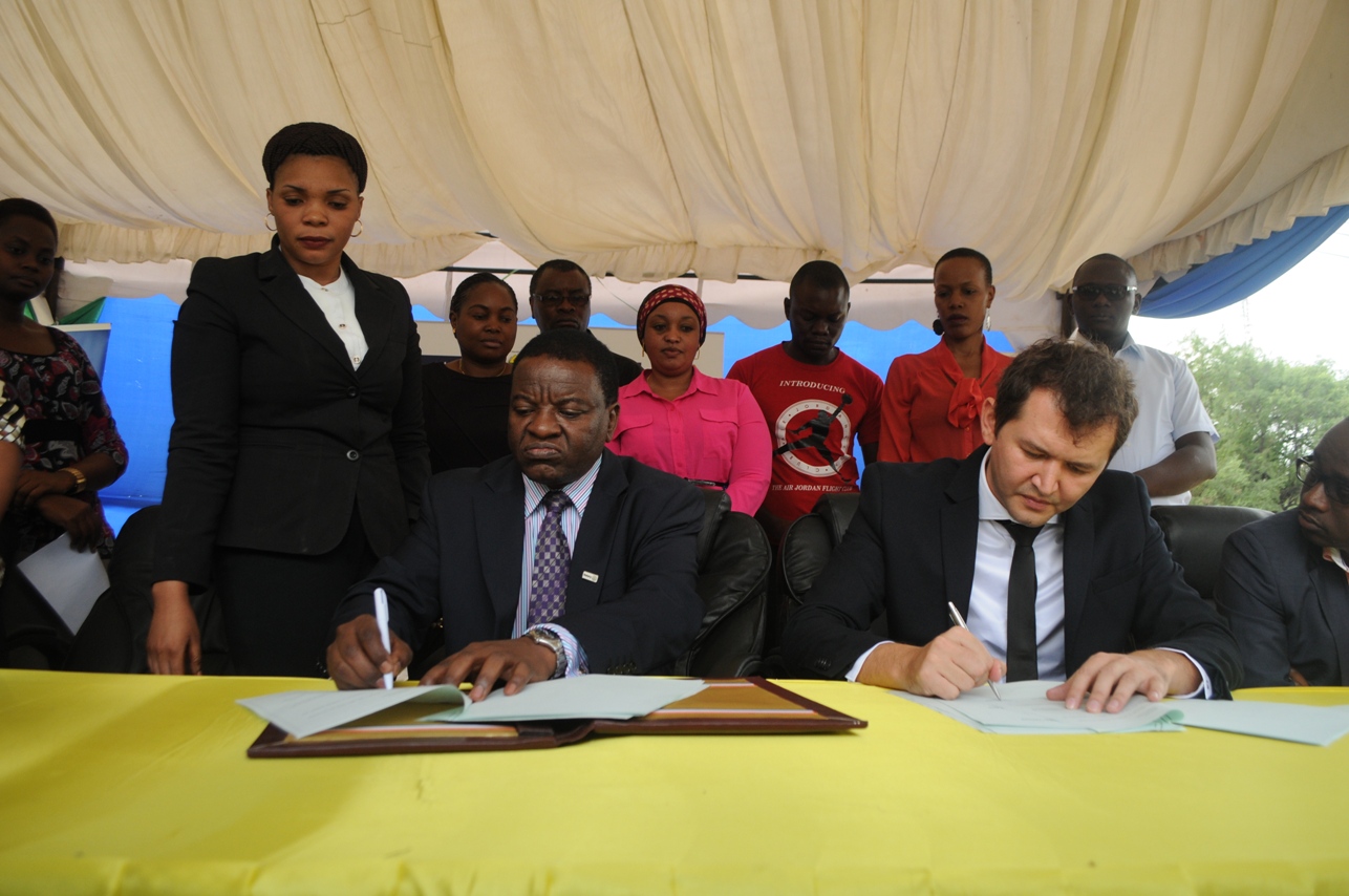 The Permanent Secretary in the Ministry of Communications, Works and Infrastructure, Prof. Faustine Kamuzora (seated, left) and Tigo Chief Commercial Officer, Shavkat Berdiev (seated, right) sign a Memorandum of Understanding in which Tigo will provide internet access to Tanzania’s secondary schools through the e-Schools Project