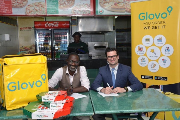 From left Joseph Claver, Simbisa Brands’ Head of Business Development and Glovo's General Manager for Kenya, William Benthall during the signing ceremony