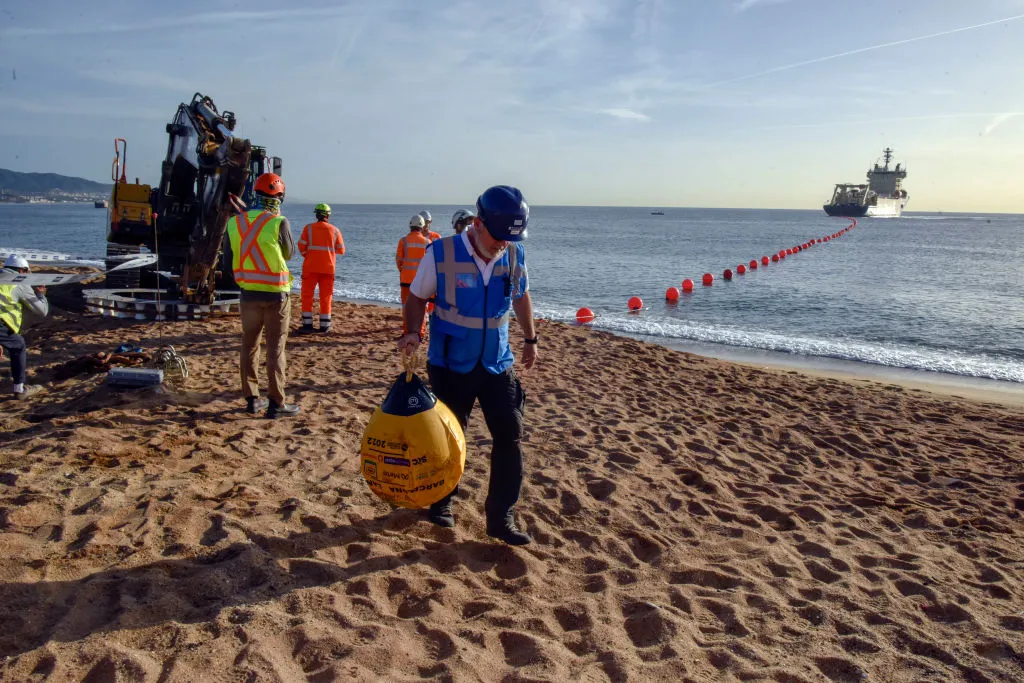 Engineers guide a subsea fiber cable ashore during a landing operation for the 2Africa network, part of the massive system designed to expand high-capacity internet connectivity across Africa, Europe, and Asia.