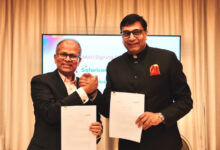 Executives from Indosat Ooredoo Hutchison and Safaricom hold signed documents during the Memorandum of Understanding ceremony announcing a partnership focused on artificial intelligence applications and financial technology collaboration aimed at improving digital customer experiences.