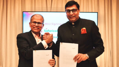Executives from Indosat Ooredoo Hutchison and Safaricom hold signed documents during the Memorandum of Understanding ceremony announcing a partnership focused on artificial intelligence applications and financial technology collaboration aimed at improving digital customer experiences.