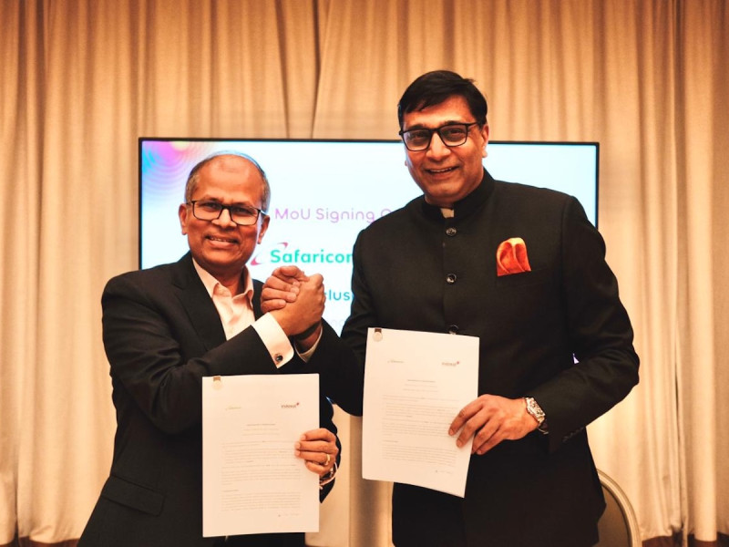 Executives from Indosat Ooredoo Hutchison and Safaricom hold signed documents during the Memorandum of Understanding ceremony announcing a partnership focused on artificial intelligence applications and financial technology collaboration aimed at improving digital customer experiences.