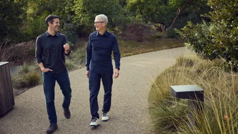 John Ternus (left) and Tim Cook walk together during a transition period that will see Ternus take over as CEO of Apple later this year.