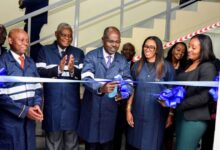 Habil Olaka and SecureID founder Kofo Akinkugbe join directors at a ribbon-cutting ceremony marking the opening of the smart card production facility in Nairobi.