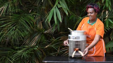 A woman demonstrates an eco-friendly cookstove in Kenya, highlighting the shift toward cleaner, more efficient household cooking solutions.