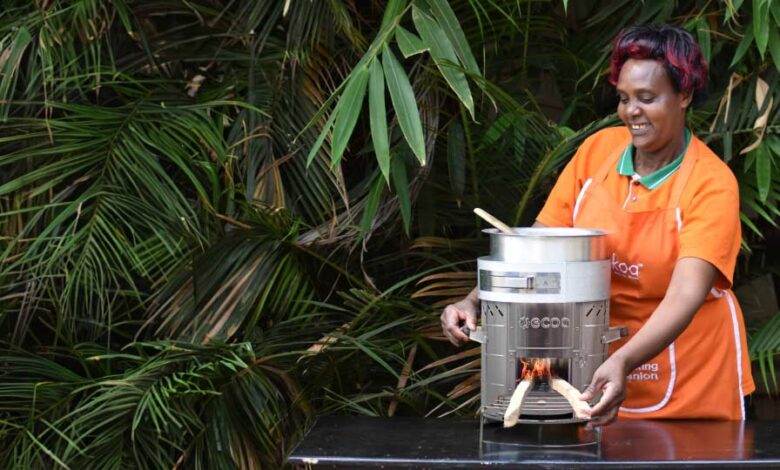 A woman demonstrates an eco-friendly cookstove in Kenya, highlighting the shift toward cleaner, more efficient household cooking solutions.