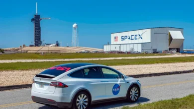 A Tesla vehicle parked near a SpaceX launch facility in Florida, reflecting the growing overlap between Musk’s automotive, aerospace and AI businesses.