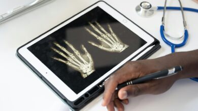 Healthcare professional reviewing X-ray images on a tablet, reflecting the growing use of digital radiology, telemedicine and technology-enabled healthcare services.