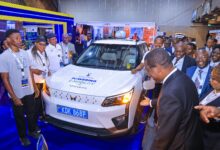 Kenya Power-branded Mahindra XUV400 electric SUV displayed at an e-mobility exhibition in Kenya, highlighting the country's growing electric vehicle market and charging infrastructure.