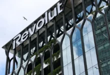 Revolut logo displayed on a modern glass office building associated with the fintech company's global expansion plans.