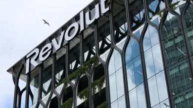 Revolut logo displayed on a modern glass office building associated with the fintech company's global expansion plans.