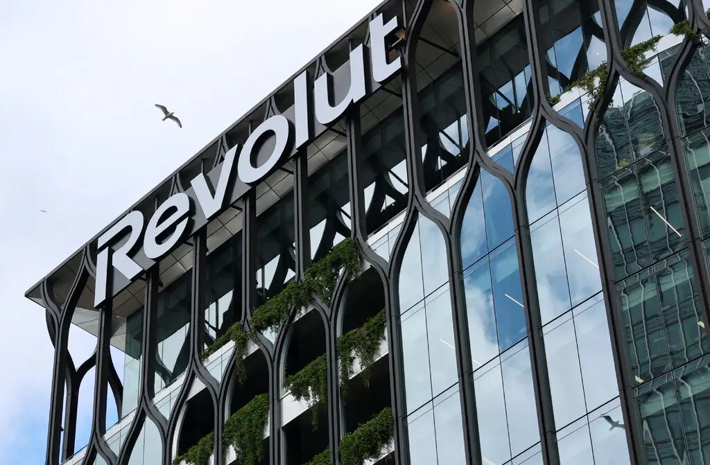 Revolut logo displayed on a modern glass office building associated with the fintech company's global expansion plans.