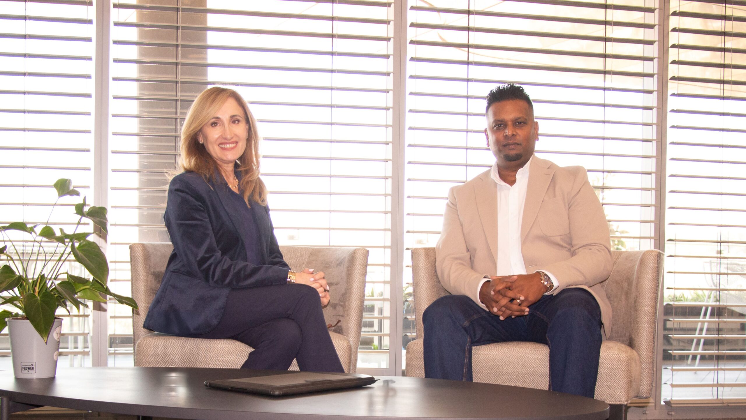 Ria Pinto of IBM South Africa and Saireshan Govender of Blue Pearl standing together during a discussion on enterprise software modernization and AI-driven development.
