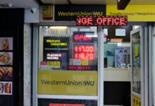 Western Union money transfer office with exchange rate display and remittance service signage.