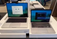 Apple MacBook Pro and MacBook Air displayed side by side on a retail showroom table.
