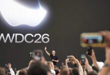 Tim Cook waves to attendees beneath a large WWDC 2026 display during Apple's annual developer conference.