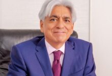 Bharat Thakrar, founder and former CEO of WPP Scangroup, seated in an office wearing a blue suit and pink tie.