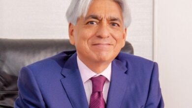 Bharat Thakrar, founder and former CEO of WPP Scangroup, seated in an office wearing a blue suit and pink tie.