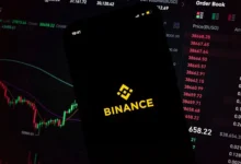 The Binance mobile app displayed against a cryptocurrency trading interface. The exchange is expanding into U.S. stock trading while preparing a tokenized equities offering for global users.