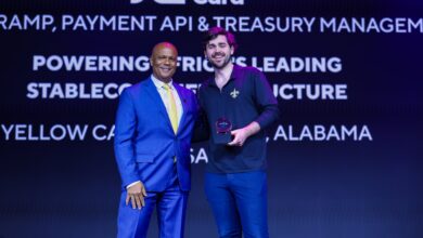 Chris Maurice of Yellow Card stands on stage holding the Grand Prix Payments Award at Money20/20 USA.