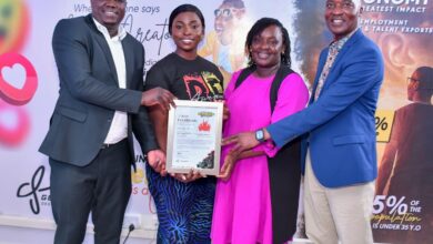 Officials present a certificate to a participant during the Jitume Digital Media Tools Sensitization Workshop graduation in Nairobi, recognizing digital media and AI skills training.