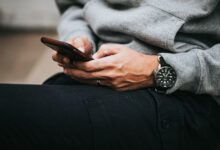 Person holding a smartphone, illustrating changing mobile communication habits in Kenya as broadband use rises and text messaging declines.