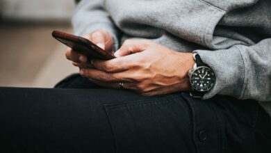 Person holding a smartphone, illustrating changing mobile communication habits in Kenya as broadband use rises and text messaging declines.