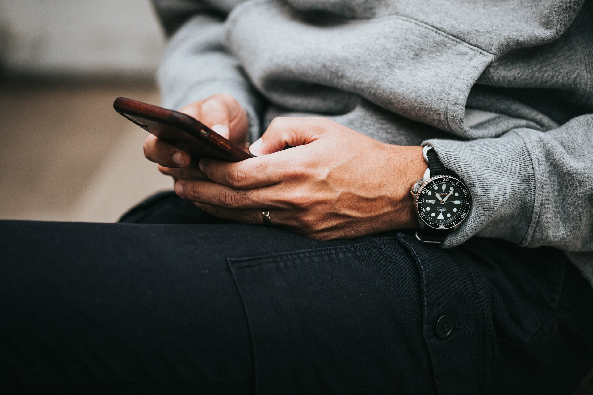 Person holding a smartphone, illustrating changing mobile communication habits in Kenya as broadband use rises and text messaging declines.
