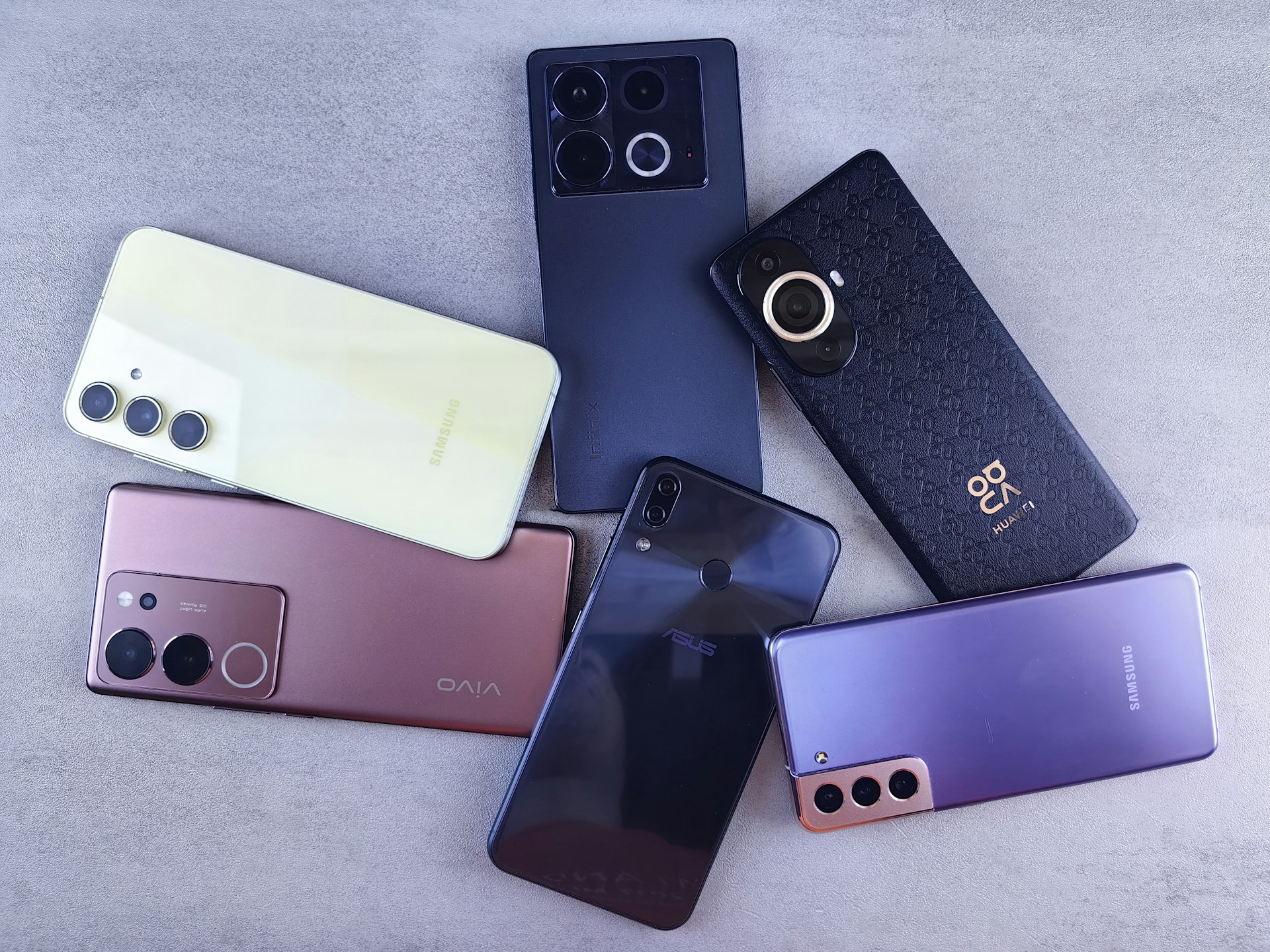Several smartphones arranged on a surface, illustrating Kenya's debate over proposed mobile phone tax changes under the Finance Bill 2026.