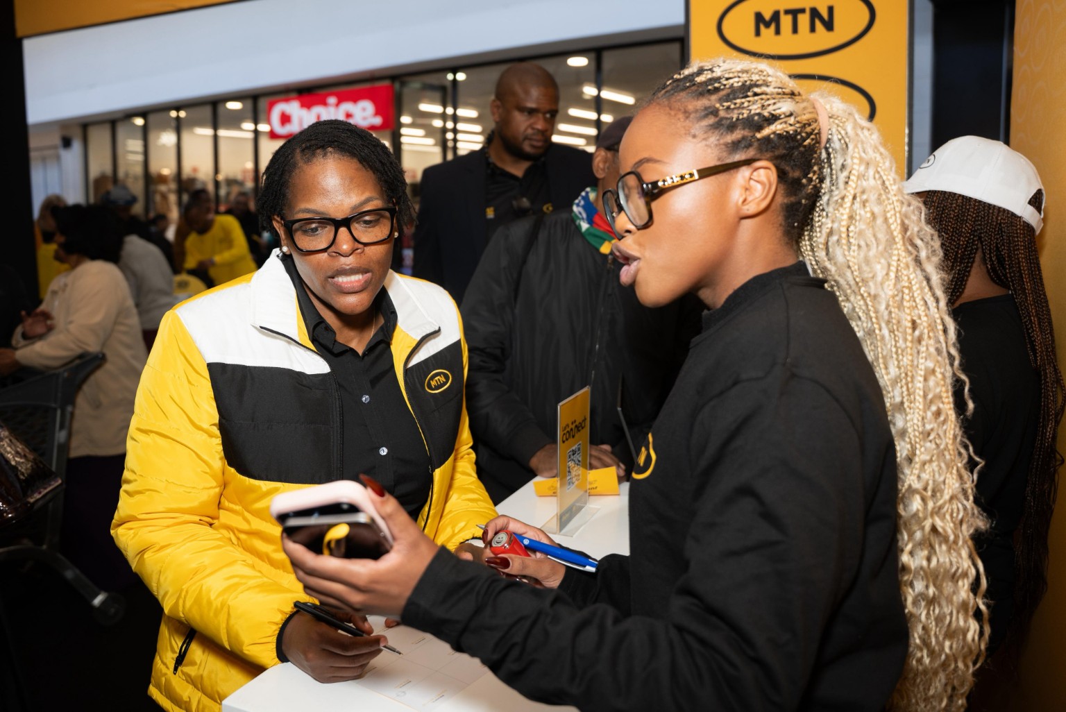 MTN staff assist customers at a branded activation event, highlighting the company's growing focus on digital services and content platforms.