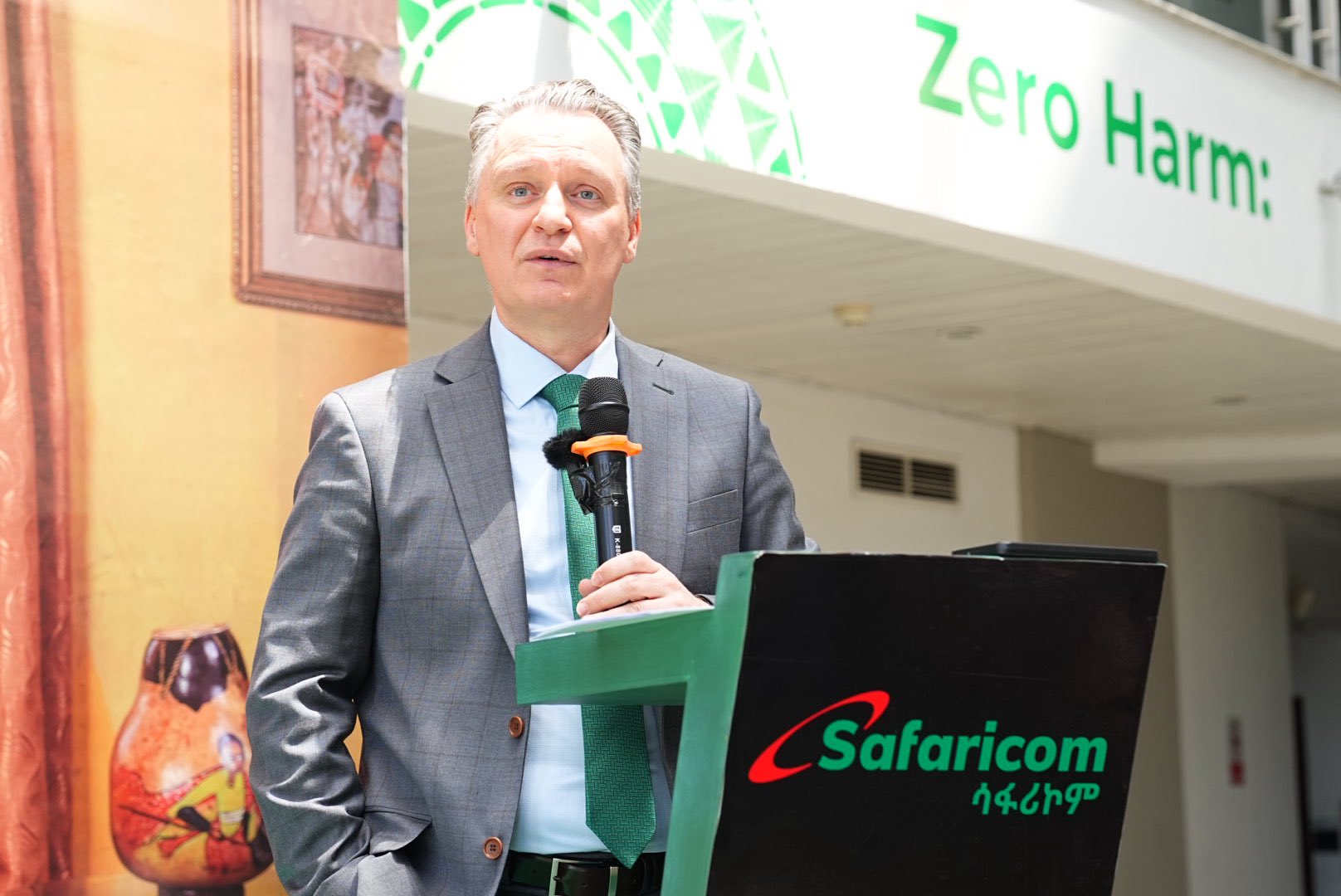 Safaricom Ethiopia CEO Wim Vanhelleputte speaking at a podium during a company event.