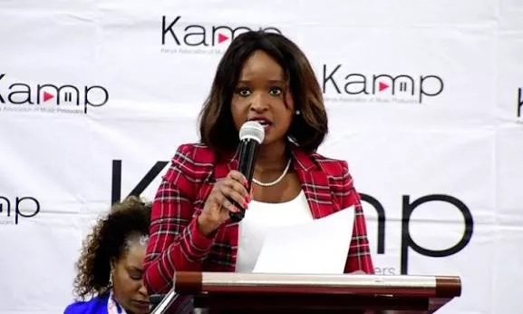 Kenya Association of Music Producers Chairperson Angela Ndambuki speaks at a podium during an official KAMP media briefing.