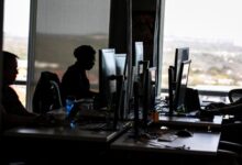 Office workers at computer stations representing AI content moderators and data annotators affected by Kenya's proposed AI worker protection policy.