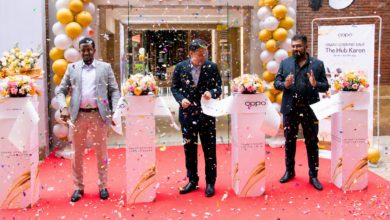 OPPO executives cut the ribbon during the opening of the new OPPO Experience Shop at The Hub Karen in Nairobi, surrounded by launch decorations and confetti.