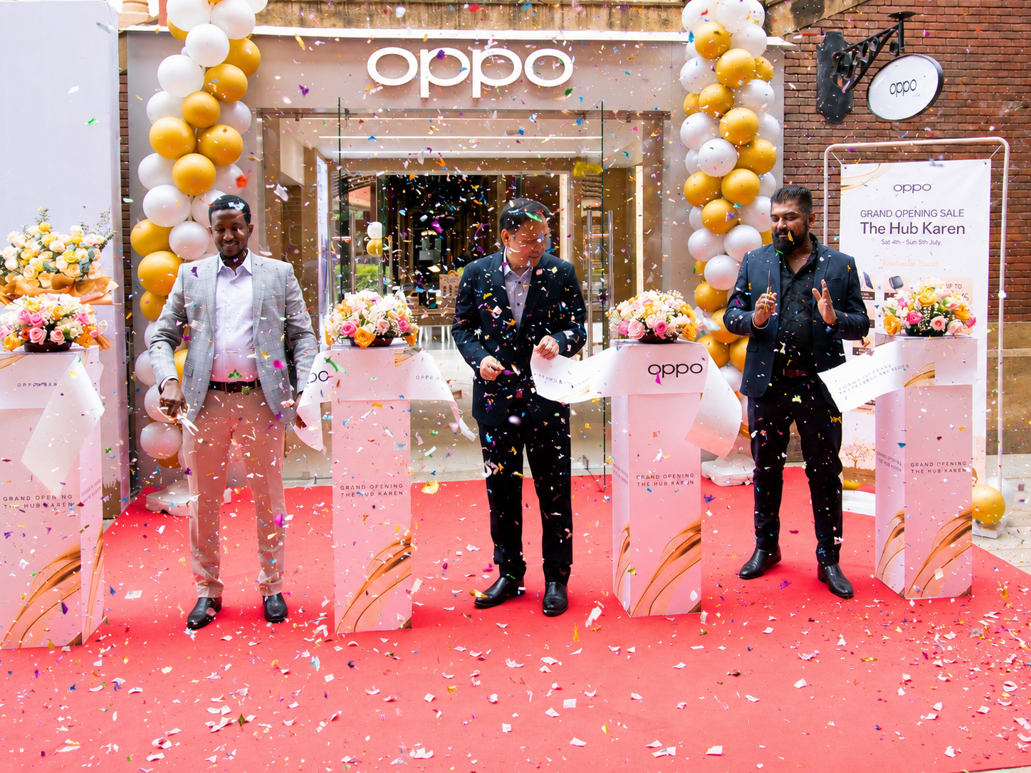 OPPO executives cut the ribbon during the opening of the new OPPO Experience Shop at The Hub Karen in Nairobi, surrounded by launch decorations and confetti.