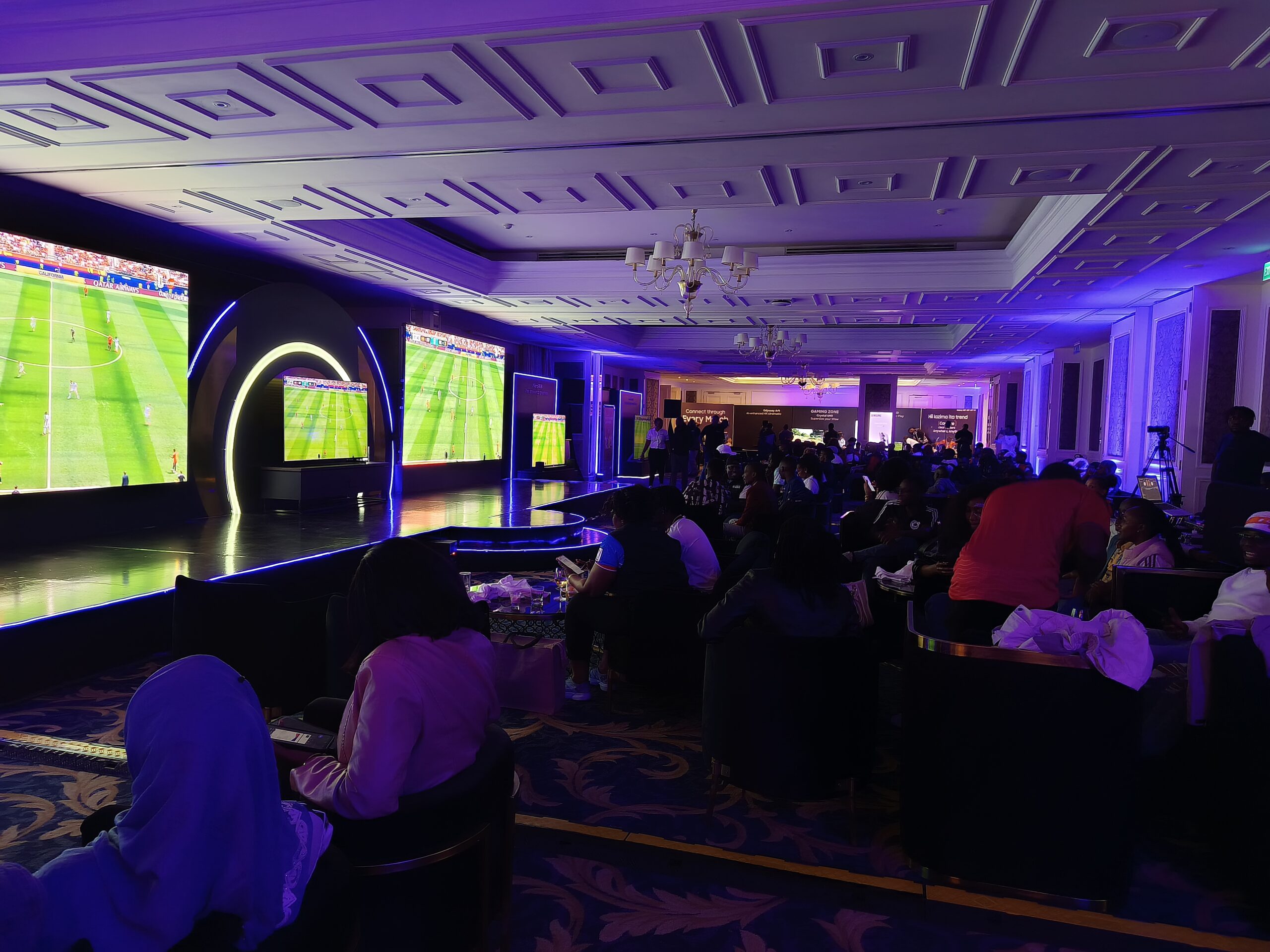 Samsung demonstrates Mini LED, OLED and Vision AI televisions during a football showcase at its 2026 TV launch event in Nairobi as attendees compare picture quality across multiple displays.