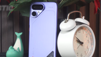 TECNO POVA Curve 2 5G in Mystic Purple showing its slim rear design and dual-camera module beside a white alarm clock.