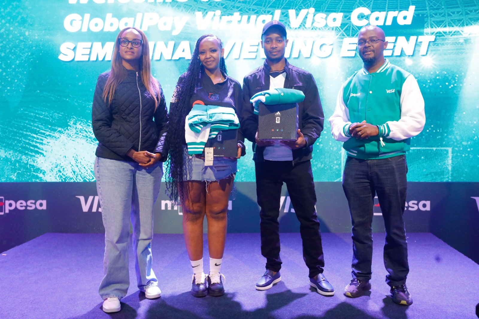 Visa and Safaricom representatives pose with winners at the Game Iko On event promoting the M-Pesa GlobalPay Virtual Visa Card.