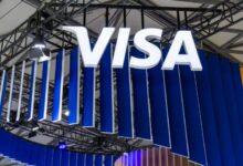 Visa logo displayed above a branded exhibition booth at a technology and payments industry event.