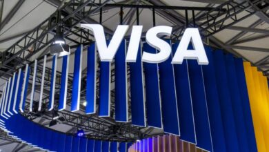 Visa logo displayed above a branded exhibition booth at a technology and payments industry event.