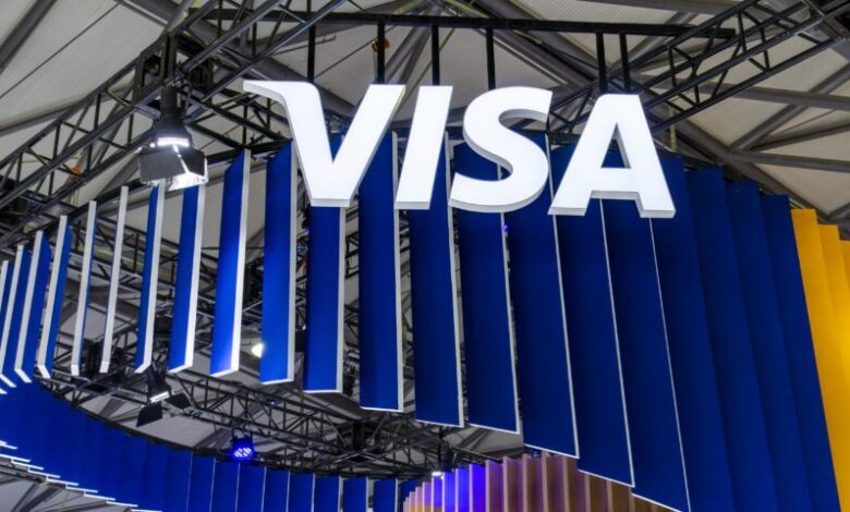Visa logo displayed above a branded exhibition booth at a technology and payments industry event.