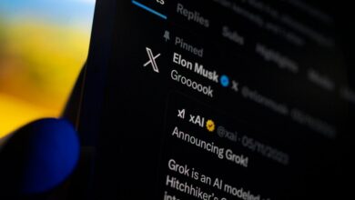 A smartphone displaying the X app with Elon Musk's profile and a Grok announcement on screen.