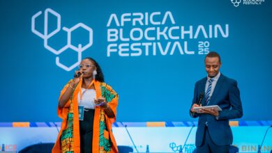 Speakers on stage beneath Africa Blockchain Festival branding during the 2025 event in Kigali.